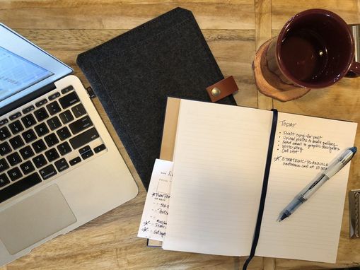 top view of laptop with coffee and book